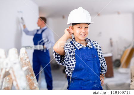 Portrait of smiling boy wearing blue overall Portrait of smiling boy wearing blue overall 119109712