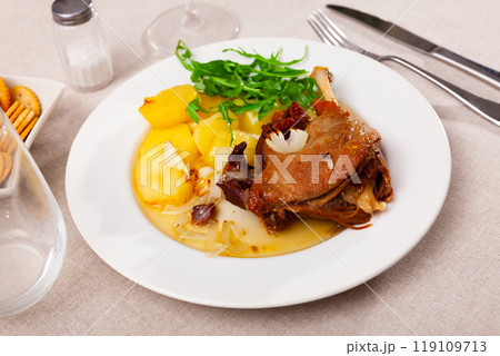 French dish duck confit with arugula on table 119109713