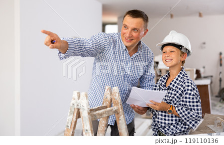 Father with little son talking about repair work in the apartment Father with little son talking about repair work in the apartment 119110136