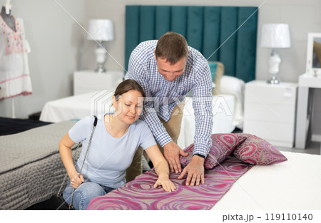 Married couple chooses the best new sofa in furniture store Married couple chooses the best new sofa in furniture store 119110140