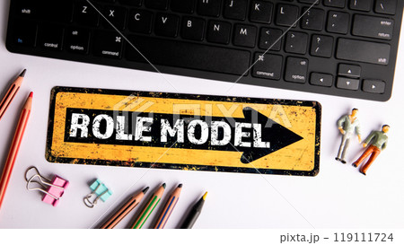 Role Model. Text on yellow arrow. Computer keyboard on the office table 119111724