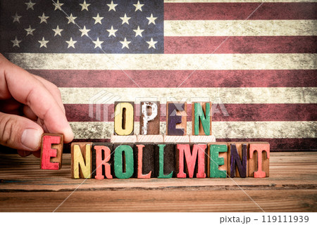 OPEN ENROLLMENT. Colorful letters of the alphabet on a wooden texture table OPEN ENROLLMENT. Colorful letters of the alphabet on a wooden texture table 119111939