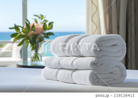 clean white towels on a hotel bed in a bright cozy room overlooking the sea clean white towels on a hotel bed in a bright cozy room overlooking the sea 119116411
