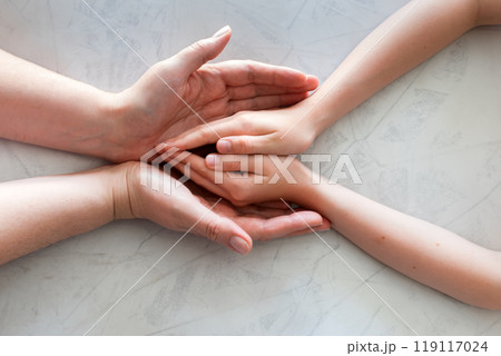 mother's hands holding baby's hands mother's hands holding baby's hands 119117024