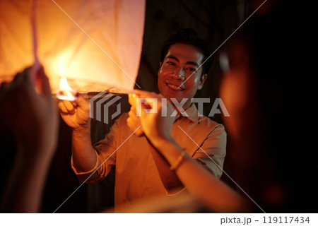 Happy Couple Celebrating Holiday With Lantern 119117434