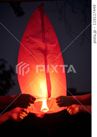 Couple Launching Lantern Into The Sky Couple Launching Lantern Into The Sky 119117449
