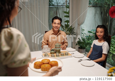 Woman Serving Moon Cake For Family Woman Serving Moon Cake For Family 119117560