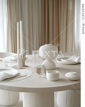 Stylish white themed table setting featuring candles, vases, and tableware, creating a harmonious and sophisticated dining atmosphere 119118390