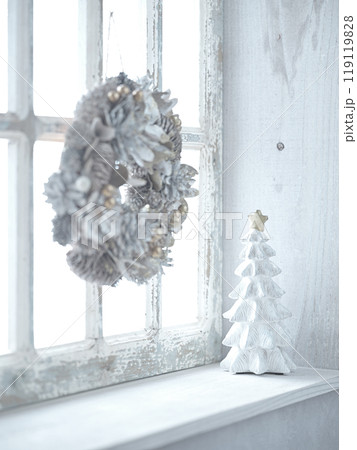 窓辺に飾られたクリスマスリースとクリスマスツリー 119119828