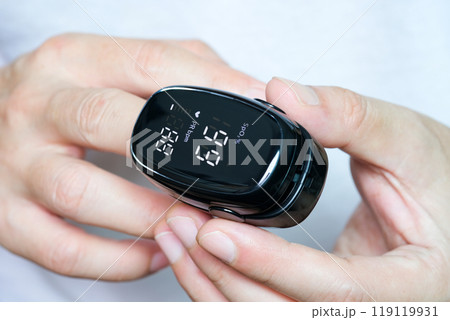A device to measure the oxygen saturation of a person at the fingertips. And checking oxygen depletion is an emergency sign of pneumonia caused by the COVID-19 virus. A device to measure the oxygen saturation of a person at the fingertips. And checking oxygen depletion is an emergency sign of pneumonia caused by the COVID-19 virus. 119119931