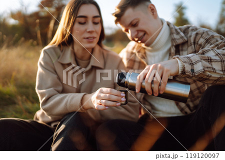 Stylish couple walking autumn weather. People, lifestyle, relaxation concept. Autumn Fashion concept Stylish couple walking autumn weather. People, lifestyle, relaxation concept. Autumn Fashion concept 119120097