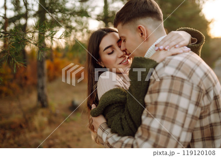 Happy couple in love newlyweds travel together, hike and walk in the autumn forest in nature. Happy couple in love newlyweds travel together, hike and walk in the autumn forest in nature. 119120108