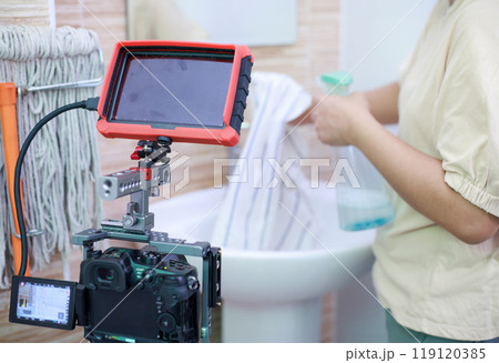 Hands of the woman uses fabric and water spray to clean the bath sink. and recording with camera Hands of the woman uses fabric and water spray to clean the bath sink. and recording with camera 119120385