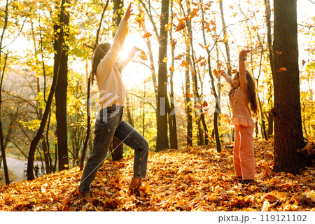 Portrait of happy mother and daughter in autumn forest at sunset. . Autumn women. Portrait of happy mother and daughter in autumn forest at sunset. . Autumn women. 119121102