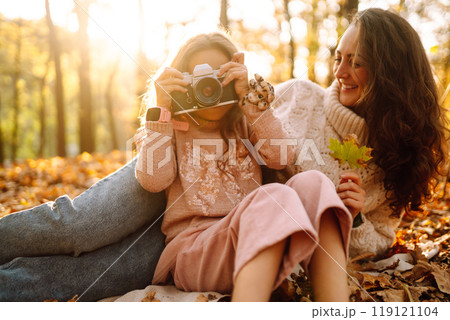 Portrait of happy mother and daughter in autumn forest at sunset. . Autumn women. Portrait of happy mother and daughter in autumn forest at sunset. . Autumn women. 119121104