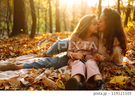 Portrait of happy mother and daughter in autumn forest at sunset. . Autumn women. Portrait of happy mother and daughter in autumn forest at sunset. . Autumn women. 119121105