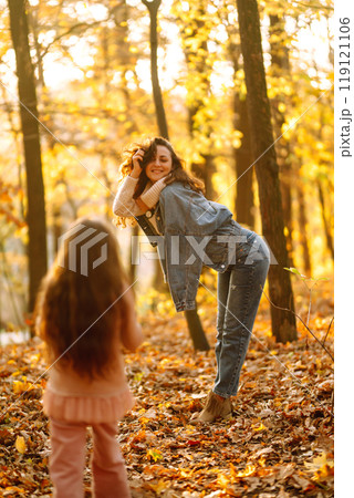 Portrait of happy mother and daughter in autumn forest at sunset. . Autumn women. 119121106