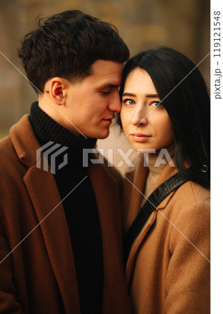 Young couple in love walking in the park on a autumn day. Enjoying time together. 119121548
