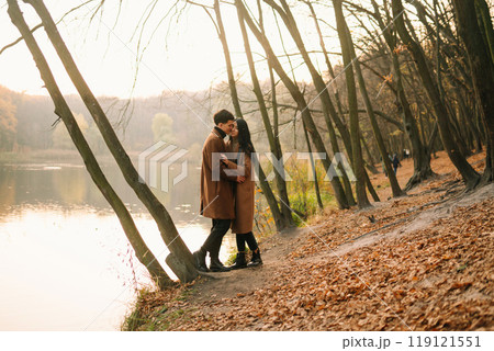 Young couple in love walking in the park on a autumn day. Enjoying time together. 119121551