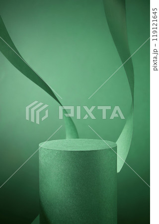 A close-up shot of a circular green podium with a soft texture on a green backdrop, with two green ribbon curves gracefully framing it, perfect for showcasing products or branding purposes. 119121645