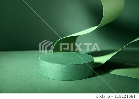 A basic product display that can be used to present a variety of items has a circular green podium on a green background that is highlighted by a flowing green ribbon. A basic product display that can be used to present a variety of items has a circular green podium on a green background that is highlighted by a flowing green ribbon. 119121661