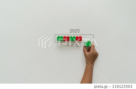 Loading new year 2024 to 2025 with child hand putting plastic block in progress bar. Loading new year 2024 to 2025 with child hand putting plastic block in progress bar. 119123501