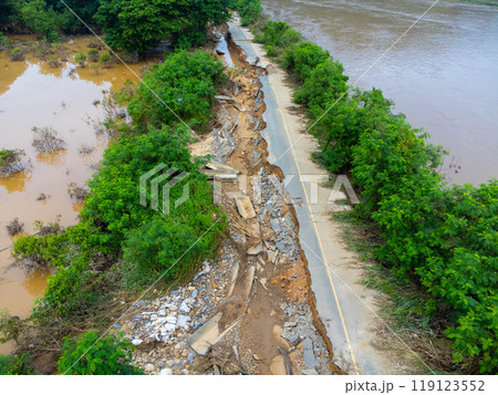 Landslides caused by heavy rains have caused the asphalt roads to crack. Natural disasters from flooding have damaged and cut off the road surface along the river. 119123552