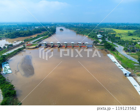 Aerial view of the dam's floodgates with rapid flow of water in the rainy season. Dam water release, dam overcapacity after heavy rain. Aerial view of the dam's floodgates with rapid flow of water in the rainy season. Dam water release, dam overcapacity after heavy rain. 119123562