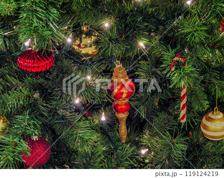 Halo of electtric lights and color balls decorating artificial Christmas tree 119124219