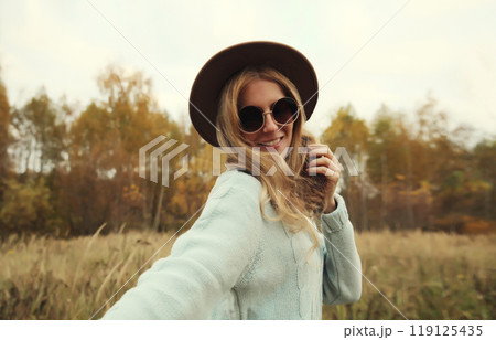 Stylish modern happy young woman having fun dancing, fashionable girl smiling outdoors, autumn park 119125435