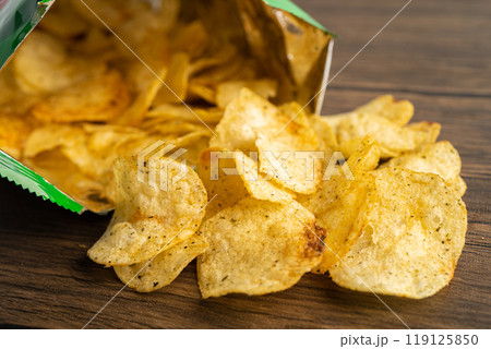 Potato chips, delicious spicy for crips, thin slice deep fried snack fast food in open bag. Potato chips, delicious spicy for crips, thin slice deep fried snack fast food in open bag. 119125850