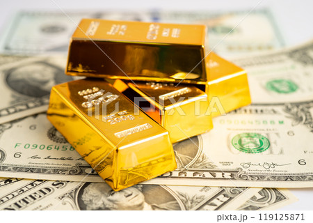 Gold bar on US dollar banknotes money and graph, economy finance exchange trade investment. 119125871