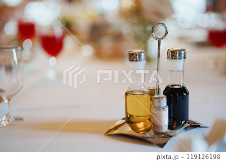 Set of containers for spices, oil and vinegar on a metal stand Set of containers for spices, oil and vinegar on a metal stand 119126198