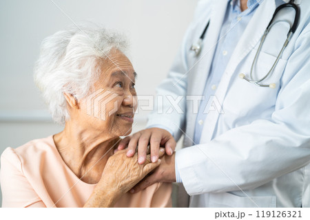 Caregiver holding hands Asian elderly woman patient with love, care, encourage and empathy at nursing hospital, healthy strong medical. 119126321