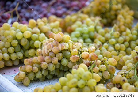 grapes displayed on a farmer's market counter 119128848