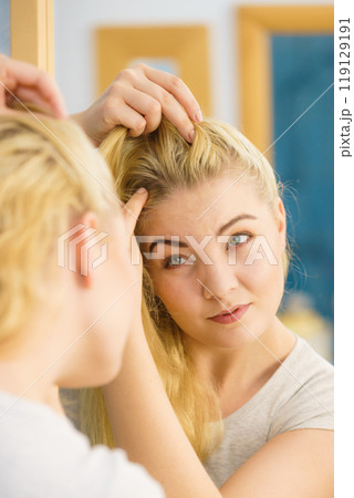 Female having problem with blonde hair 119129191