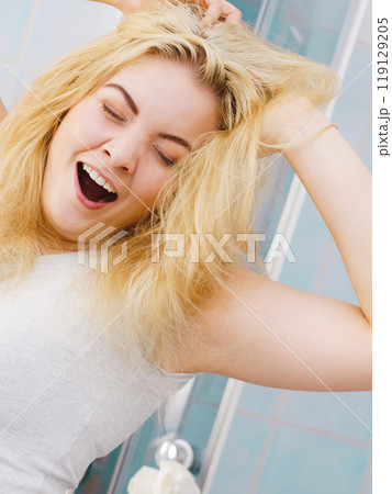 Happy fresh blonde woman in bathroom 119129205
