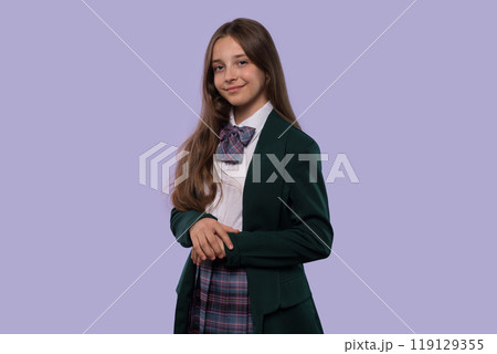 Young girl in school uniform posing confidently 119129355