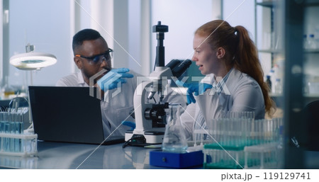Diverse team of two scientists working on creating new drugs 119129741