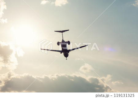 Business jet landing in backlight Business jet landing in backlight 119131325