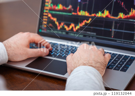 Close-up of male hands using laptop and typing on keyboard. Modern remote work and business. Online trading Close-up of male hands using laptop and typing on keyboard. Modern remote work and business. Online trading 119132044