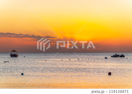 Beautiful yellow and orange sunrise over the sea. Beautiful yellow and orange sunrise over the sea. 119138871