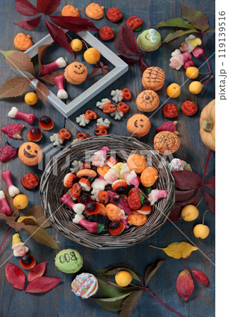 Wooden Halloween candy board. Holidays and Food. Dessert in shape of pumpkin, skull, witch.  119139516