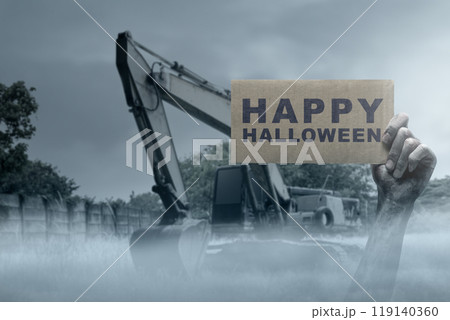 Zombie hand with bloody wound rising out of ground holding cardboard with a Happy Halloween sign. Zombie, devil, evil, satan, or monster hands 119140360