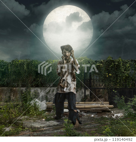 Zombie with bloody wound standing with full moon background. Scene is scary and creepy 119140492
