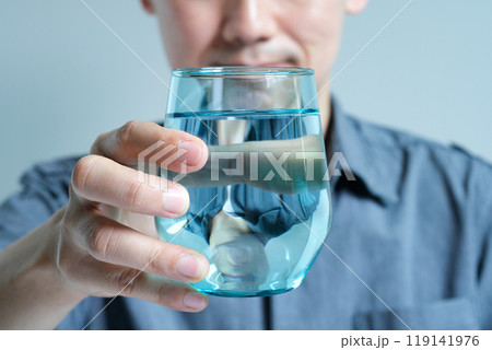 In the Morning, hand of man holding a clear glass of water for drinking. In the Morning, hand of man holding a clear glass of water for drinking. 119141976