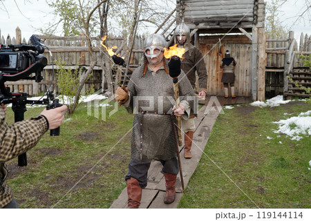 Filming Historical Reenactment with Actors Holding Torches Filming Historical Reenactment with Actors Holding Torches 119144114
