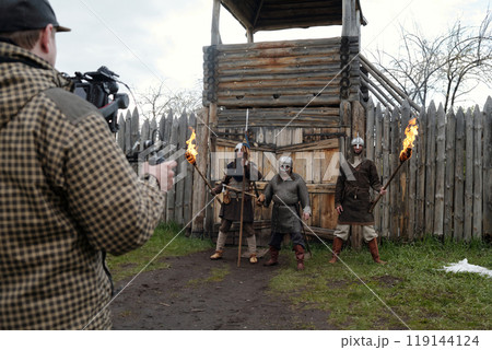 Filming Medieval Warriors at Wooden Fort with Torches 119144124