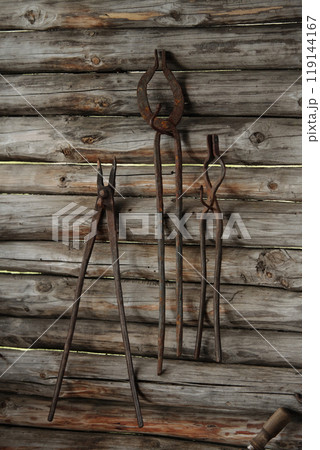 Old Rusty Metal Tools Hanging on Wooden Shed Wall Old Rusty Metal Tools Hanging on Wooden Shed Wall 119144167