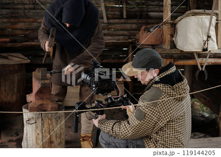 Filming Traditional Blacksmith Working in Workshop Filming Traditional Blacksmith Working in Workshop 119144205